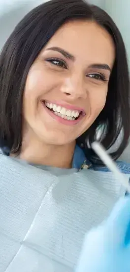 Smiling woman in dental chair during examination at Silver Spring dental practice.